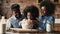 Happy african american family cooking together in kitchen.