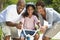 Happy African American Family & Girl Riding Bike