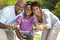 Happy African American Family & Girl Riding Bike