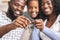 Happy african american family holding keys from their new home