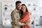 Happy African American Family Military Husband And Wife Embracing At Home