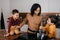 Happy african american family mom and two sons having fun cooking lunch in the kitchen