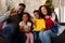 Happy african american family waving, having video call, christmas decorations in background