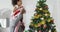 Happy african american fatherand daughter decorating christmas tree