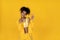 Happy african american girl wear stylish yellow clothes isolated on background