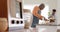 Happy african american grandfather and grandson talking, baking in kitchen, slow motion