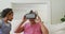Happy african american grandmother using vr headset with granddaughter in living room