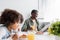 happy african american grandparent reading newspaper