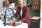 Happy african american grandparents and grandson washing vegetables in kitchen, slow motion