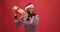Happy african american guy in winter sweater and santa hat dancing with Christmas gift box, trying to guess present