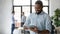 Happy african American male employee use tablet in office