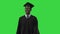 Happy African American Male Student in graduation robe walking on a Green Screen, Chroma Key.