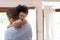 Happy African American Man hugging with little kid boy with eyes closed when he arriving at home. Black Father in blue shirt and