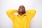 Happy african american man laughing with hands behind head against white background