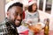 Happy african american man looking at camera at christmas table