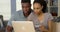 Happy African American man and woman making online purchase with credit card