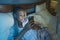 Happy African American millennial woman as social media addict - night lifestyle portrait of young beautiful and cool black girl