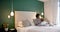 Happy african american mother combing daughter hair sitting on bed in bedroom, slow motion