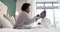 Happy african american mother combing daughter hair sitting on bed in bedroom, slow motion