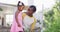 Happy african american mother and daughter gardening and talking, mother holding trowel