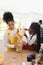 Happy african american mother and daughter pouring pasta to glass jar in kitchen at home, copy space