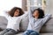 Happy African American mother and teen daughter relaxing together