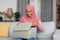 Happy african american muslim woman opening delivery box and looking inside, unboxing parcel with purchases