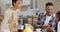 Happy african american parents and daughter having breakfast at table, slow motion