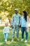 happy african american soldier in military uniform holding hands with daughter and wife