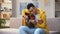 Happy African-American teenager playing guitar, enjoying favorite hobby, leisure