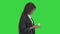 Happy African American woman counting money while walking on a Green Screen, Chroma Key.