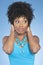 Happy African American woman covering ears over while looking away colored background