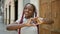 Happy african american woman making lovely heart sign with hands on urban street, radiating joy and confidence