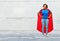 Happy african american woman in superhero red cape