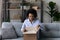 Happy African American woman unpack box with internet order