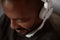 Happy African black man listening to music relaxing on sofa couch with headphones in home living room.Closeup portrait.