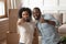 Happy african couple takes selfie photo carton boxes on background