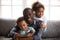 Happy african dad and mixed race children at home portrait