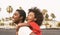 Happy African family on the beach during summer holidays - Afro American people having fun on vacation time