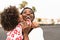 Happy African family on the beach during summer holidays - Afro American people having fun on vacation time