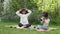 Happy African family with children sitting using binoculars for learning the garden