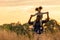 Happy African family father and child daughter travel and running on meadow nature on silhouette lights sunset.