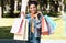 Happy African Girl Holding Colorful Shopper Bags Standing Outdoor