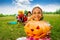 Happy African girl holds Halloween pumpkin