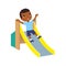 Happy African little  boy slides off a children`s slide. Joyful dark skin child, summer vacation
