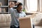 Happy african male customer hold cardboard box open post parcel
