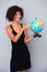 Happy african woman holding globe