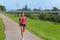 Happy African woman jogging on a rural footpath