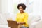 Happy african young woman with parcel box at home