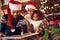 Happy afro American family read a book at fireplace on Christmas